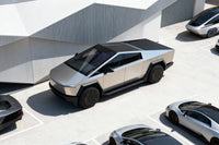 Silver futuristic truck in a parking lot with other vehicles