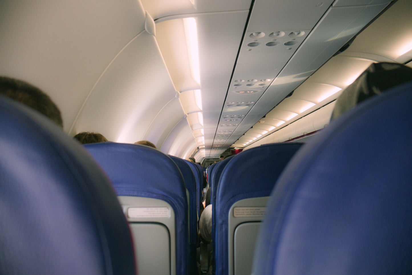 Economy class airplane interior - where Air Comfort Travel Cushion saves your tailbone